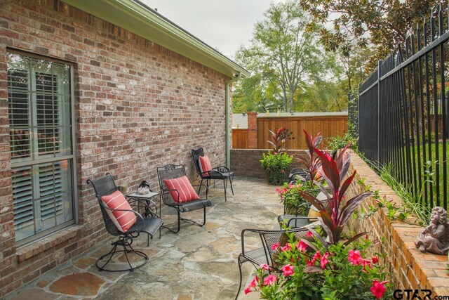 view of patio / terrace featuring fence