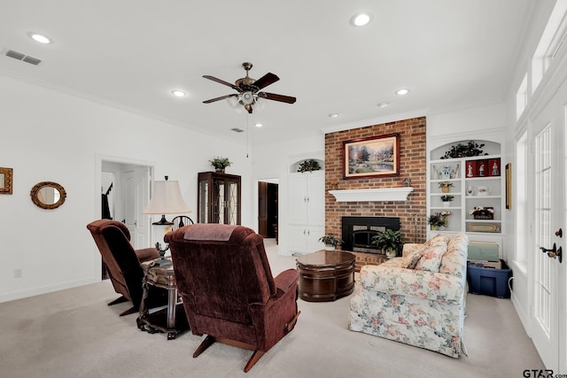 carpeted living room featuring ornamental molding, a fireplace, and ceiling fan