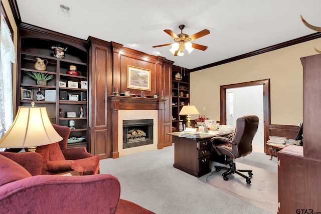 office featuring ceiling fan, light carpet, and ornamental molding