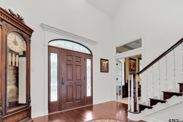 entryway with hardwood / wood-style flooring, plenty of natural light, and high vaulted ceiling