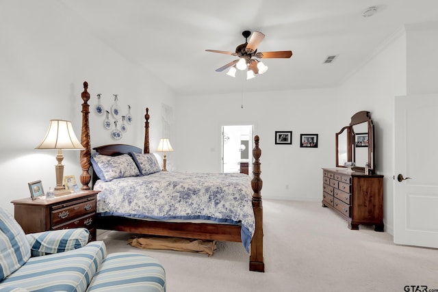 carpeted bedroom featuring ceiling fan and ornamental molding