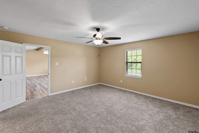 unfurnished room featuring carpet floors, ceiling fan, and baseboards