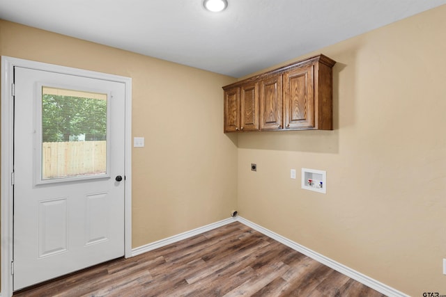 laundry area featuring wood finished floors, baseboards, cabinet space, washer hookup, and hookup for an electric dryer