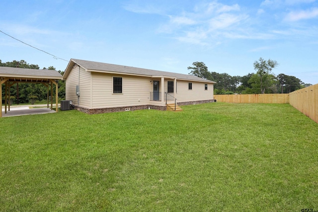 rear view of property with fence, a lawn, and cooling unit