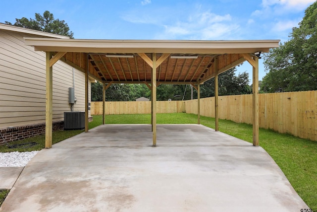 view of patio featuring a fenced backyard, a carport, and central AC