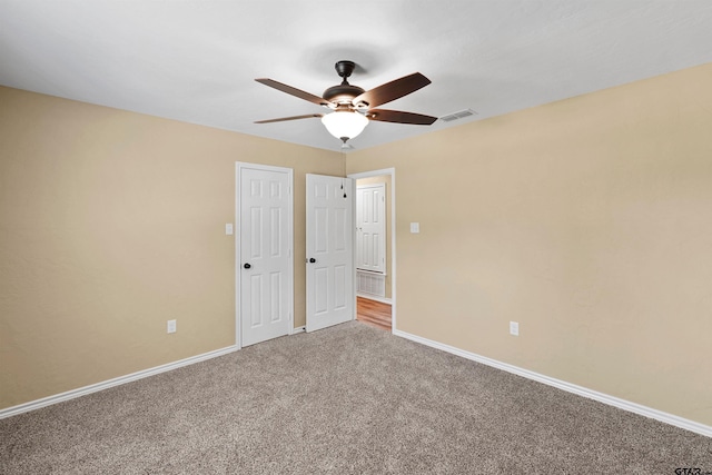 unfurnished bedroom with baseboards, ceiling fan, carpet flooring, and visible vents
