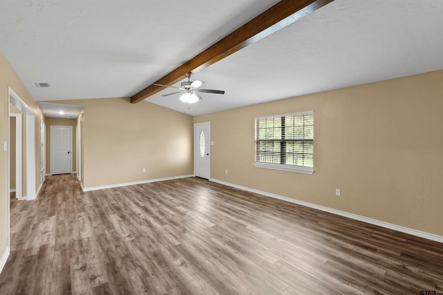 unfurnished living room featuring a ceiling fan, visible vents, wood finished floors, baseboards, and vaulted ceiling with beams