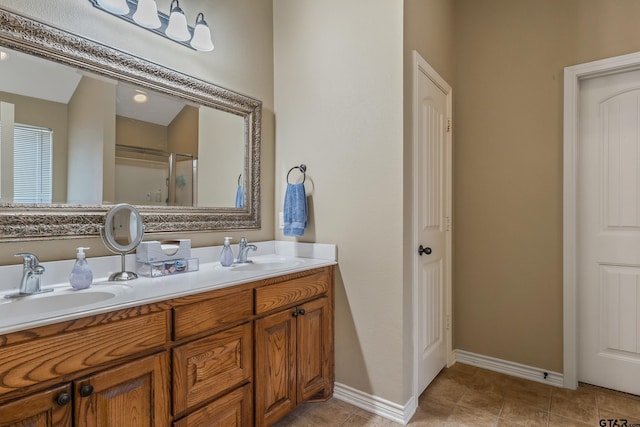 bathroom with a sink, baseboards, double vanity, and a shower stall