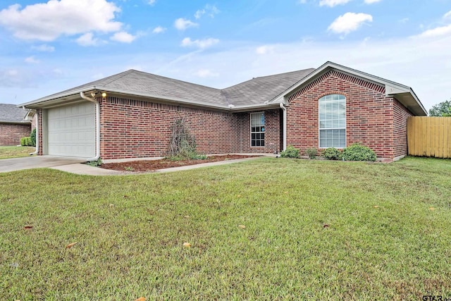 ranch-style house featuring a garage, brick siding, concrete driveway, and a front yard