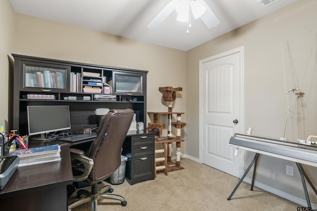 office area with visible vents, light colored carpet, baseboards, and ceiling fan