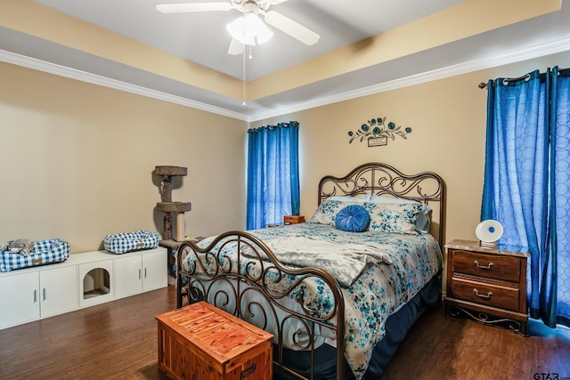 bedroom with dark wood finished floors, a raised ceiling, ceiling fan, and ornamental molding