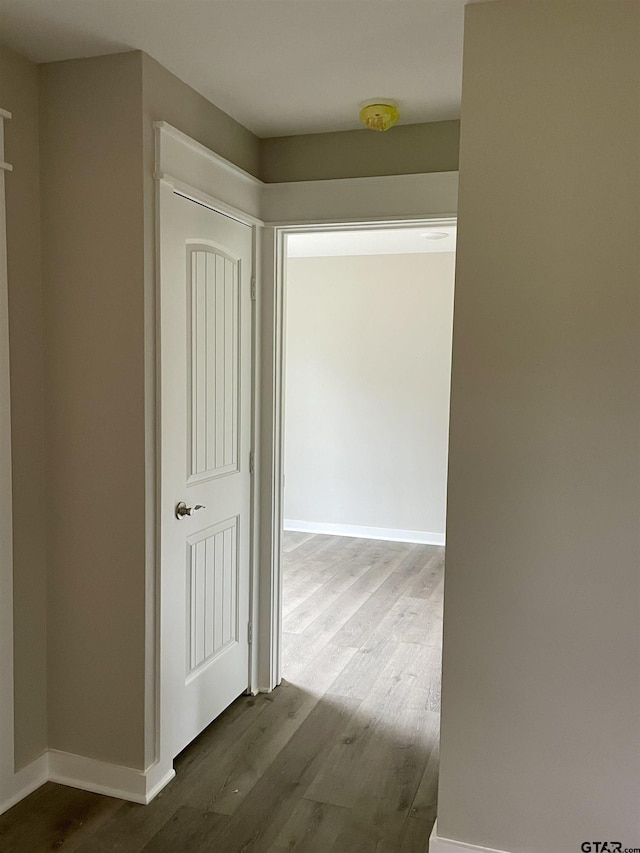 hall with hardwood / wood-style flooring