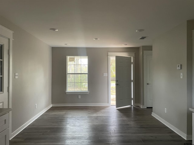 unfurnished room with dark hardwood / wood-style flooring