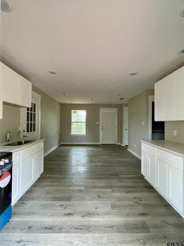 kitchen featuring sink, white cabinets, and light wood-type flooring