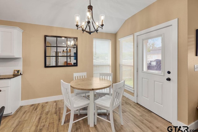 17127 Meadowview Ln, Lindale, TX 75771 - dining room featuring a chandelier, light wood-type flooring, and vaulted ceiling