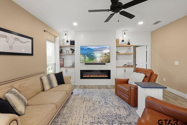 17127 Meadowview Ln, Lindale, TX 75771 - living area with light wood-type flooring, a fireplace, ceiling fan, and recessed lighting