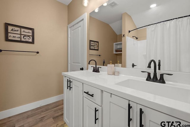 17127 Meadowview Ln, Lindale, TX 75771 - bathroom with double vanity, wood finished floors, lofted ceiling, and a shower with curtain