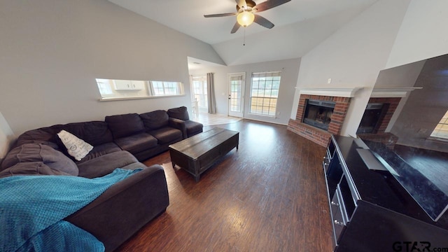 living room with a fireplace, dark hardwood / wood-style flooring, ceiling fan, and high vaulted ceiling