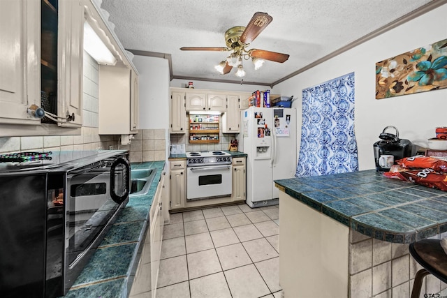 kitchen with ornamental molding, ceiling fan, a textured ceiling, white appliances, and decorative backsplash