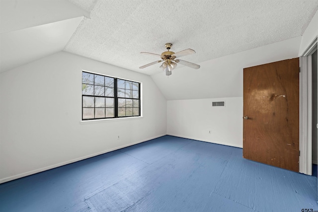 additional living space featuring ceiling fan, a textured ceiling, and vaulted ceiling