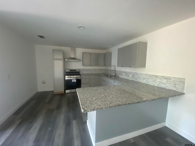 kitchen with gray cabinetry, dark hardwood / wood-style flooring, sink, stainless steel range, and kitchen peninsula