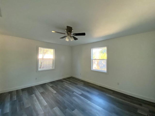 spare room featuring ceiling fan, plenty of natural light, and dark hardwood / wood-style flooring