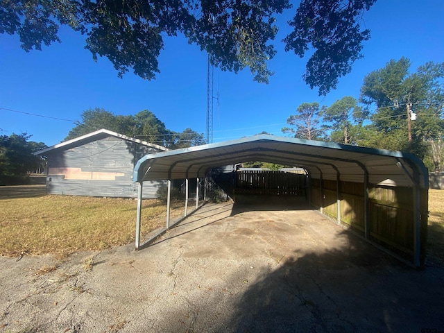 view of parking / parking lot with a carport and a lawn