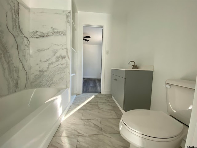 bathroom featuring ceiling fan, vanity, and toilet