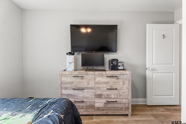 bedroom featuring baseboards and light wood-style floors