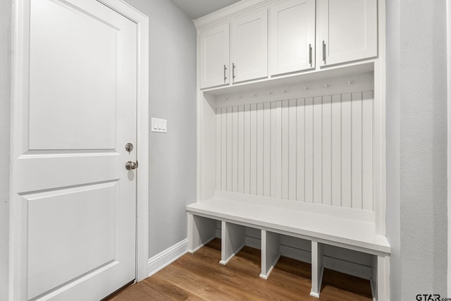 mudroom with wood finished floors and baseboards