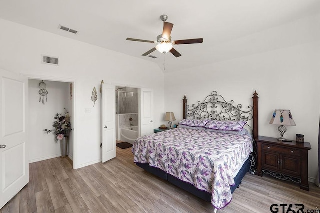 bedroom featuring a ceiling fan, visible vents, and wood finished floors