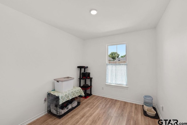 miscellaneous room featuring wood finished floors and baseboards