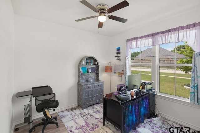 home office featuring ceiling fan, wood finished floors, and baseboards