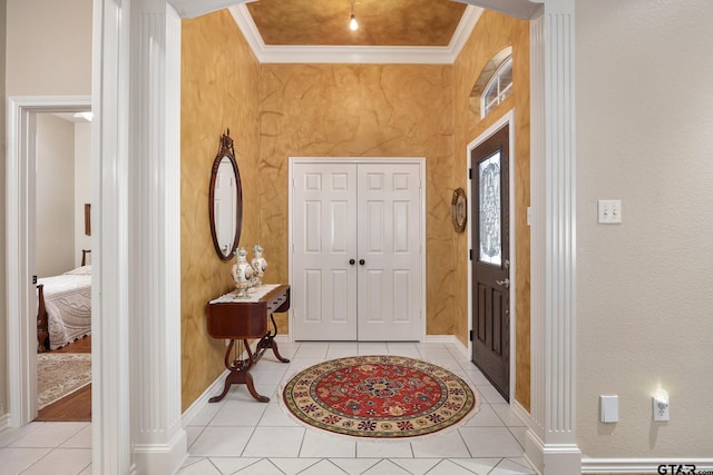 tiled entrance foyer featuring ornamental molding