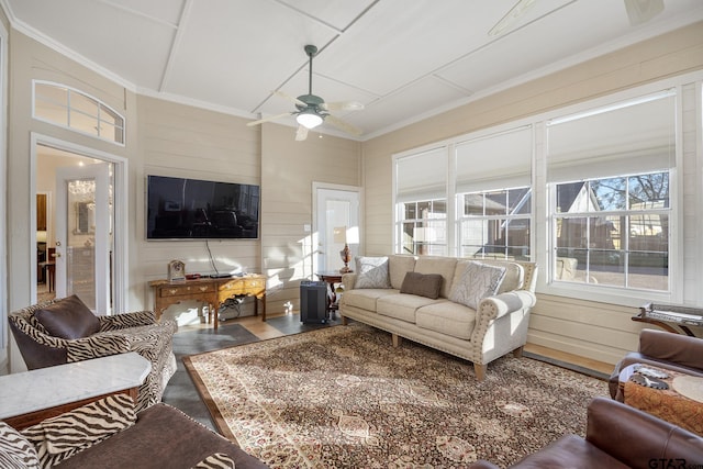 living room with ceiling fan and ornamental molding