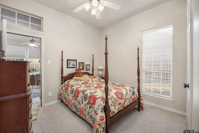 bedroom featuring multiple windows, ceiling fan, and light carpet