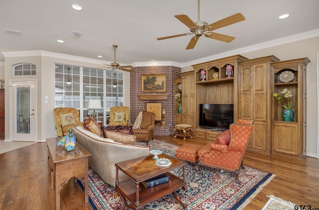 living room with ceiling fan, light hardwood / wood-style floors, and ornamental molding