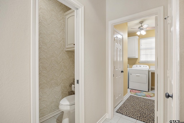 bathroom featuring tile patterned flooring, washer / dryer, toilet, and ceiling fan