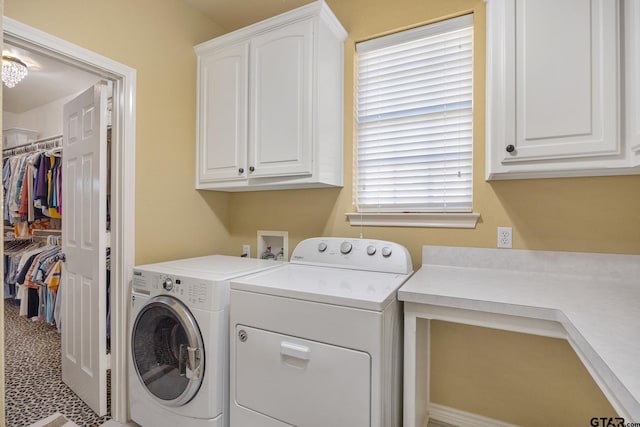 laundry room featuring cabinets and washing machine and clothes dryer