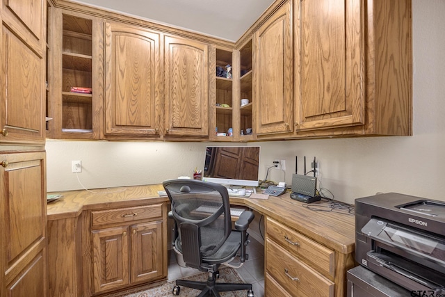 home office featuring tile patterned flooring and built in desk