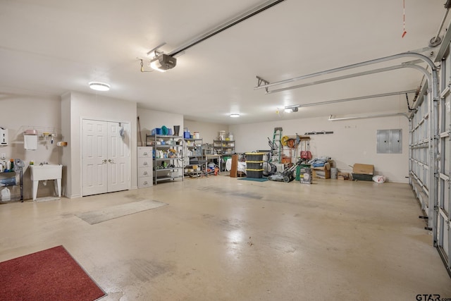 garage featuring electric panel and a garage door opener