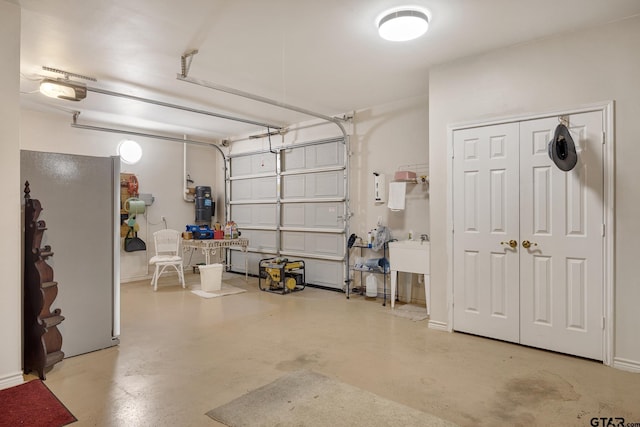 garage featuring white fridge and a garage door opener