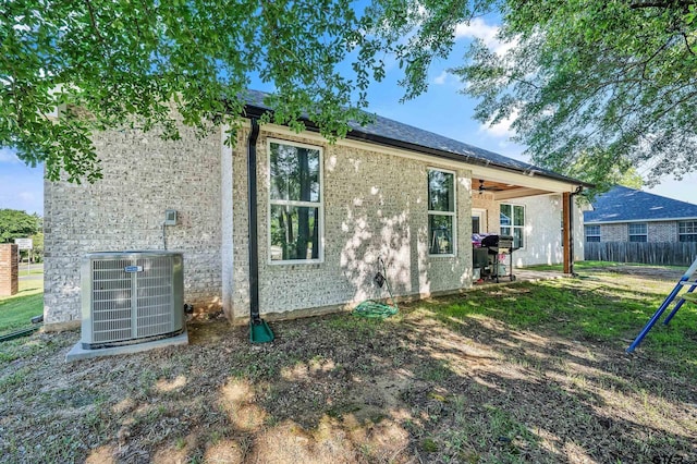 519 Crystal Ave, Rusk, TX 75785 - back of property featuring cooling unit, ceiling fan, fence, and brick siding