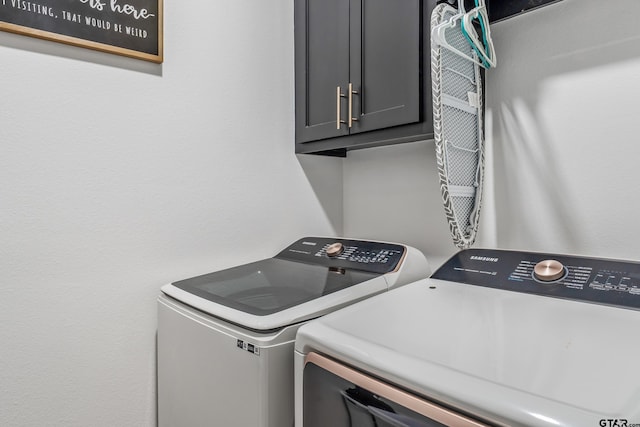 519 Crystal Ave, Rusk, TX 75785 - clothes washing area featuring washing machine and clothes dryer and cabinet space