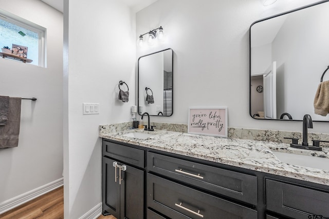 519 Crystal Ave, Rusk, TX 75785 - full bathroom featuring wood finished floors, baseboards, and double vanity
