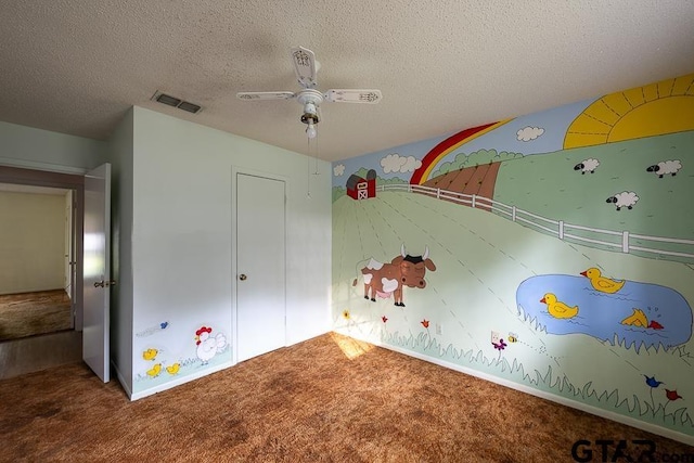 unfurnished bedroom featuring visible vents, ceiling fan, a textured ceiling, and carpet