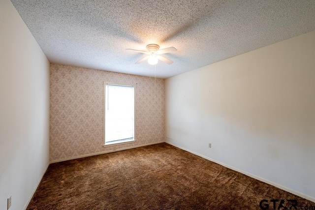 spare room featuring carpet flooring, a textured ceiling, and ceiling fan