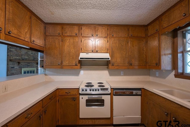 kitchen featuring brown cabinetry, white appliances, and range hood
