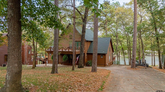 view of front facade with a garage and a deck with water view