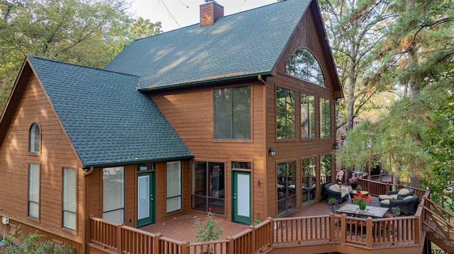 rear view of house featuring a wooden deck